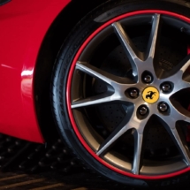 Close Up Of A Silver Ferrari Alloy Wheel, With Red AlloyGator Wheel Rim Protector And Red Break Calliper