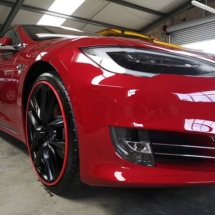 Side View Of Red Tesla With Red AlloyGators