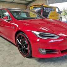 Side View Of Red Tesla With Red AlloyGators