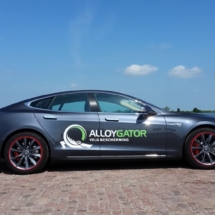Side View Of Grey Tesla Model S Silver Alloy Wheel With Red AlloyGator Wheel Protector & Red Callipers