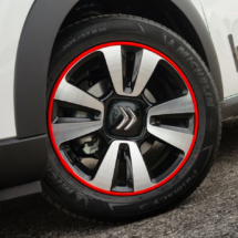 Close up of Citroen alloy wheel with a Red AlloyGator wheel protector