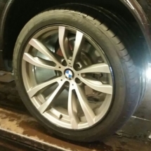 Close Up View Of Silver BMW Alloy Wheel With Black AlloyGator Wheel Protector