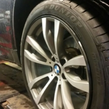 Side View Of Silver BMW Alloy Wheel With Black AlloyGator Wheel Protector