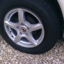 Close Up View Of Caravan With Silver Alloy Wheels And Black AlloyGator Wheel Protection