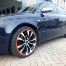 Side View Of Blue Audi With Silver Alloy Wheels And Orange AlloyGator Wheel Protection