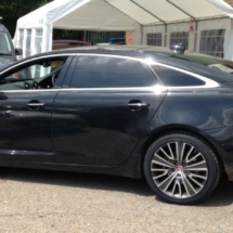 Black Jaguar With Silver & Black Alloy Wheels And Black AlloyGator Wheel Protection In A Car Park