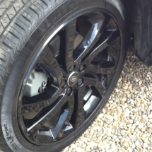 Close Up Of Black Land Rover Alloy Wheels With Black AlloyGator Wheel Protection On Gravel
