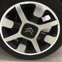 Close up of Citroen C3 alloy wheel with a white AlloyGator wheel protector