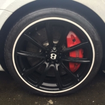 Close Up Of White Bentley With Black Alloy Wheels, Red Brake Callipers And White AlloyGator Wheel Protection