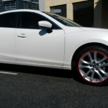 Side View Of Mazda With Silver Alloy Wheels And Red AlloyGator Alloy Wheel Protection