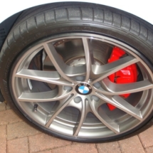 Close Up Of Silver BMW Alloy Wheel With Black AlloyGator Wheel Protection & Red Brake Callipers