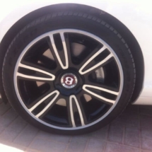 Close Up View Of White Bentley With Silver Alloy Wheels With Silver AlloyGator Wheel Protector