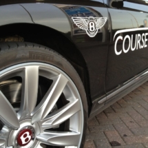 Close Up Side View Of Black Bentley With Silver Alloy Wheels With Silver AlloyGator Wheel Rim Protector