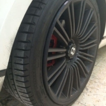 Close Up Of Rear Black Bentley Alloy Wheel With Black AlloyGator Wheel Rim Protector