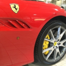 Close Up View Of Front Wheel Of A Red Ferrari With Silver Alloy Wheels, Black AlloyGator Alloy Wheel Protector & Yellow Brake Callipers