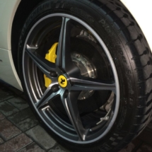 Close Up View Of Front Wheel Of A Silver Ferrari With Silver Alloy Wheels, Silver AlloyGator Alloy Wheel Protector & Yellow Brake Callipers