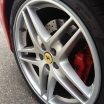 Close Up Of Red Ferrari And Its Silver Alloy Wheel, Red Brake Calliper & Silver AlloyGator Alloy Wheel Protector
