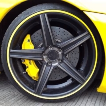 Close Up Of A Yellow Ferrari Front Alloy Wheel With Yellow AlloyGator Wheel Rim Protector And Yellow Break Callipers