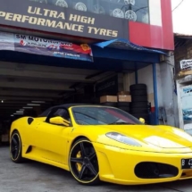 Side View Of A Yellow Ferrari Front Alloy Wheel With Yellow AlloyGator Alloy Wheel Protector And Yellow Brake Callipers