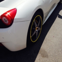 Rear View Of A White Ferrari With Silver Alloy Wheels And Yellow AlloyGator Wheel Rim Protector