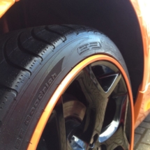 Close Up Of An Orange Fords Black Alloy Wheels With Orange AlloyGator Alloy Wheel Protector