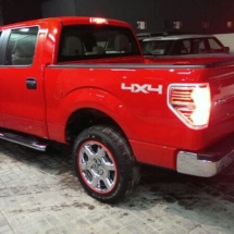 Side View Of Red Ford Pick Up With Silver Alloy Wheels & Red AlloyGator Alloy Wheel Protectors