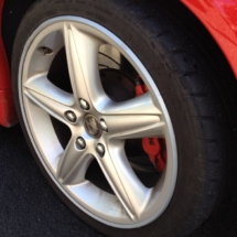 Close Up Of Holden Silver Alloy Wheel With Silver AlloyGator Wheel Protector And Red Brake Calliper
