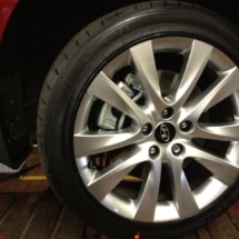 Close Up Of Red Hyundai With Silver Alloy Wheels And Black AlloyGator Alloy Wheel Protector