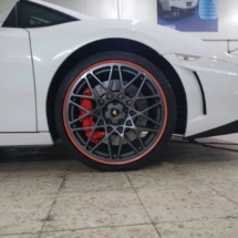 Close Up Of The Front Of A Lamborghini With Black Alloy Wheels And Red AlloyGator Alloy Wheel Protectors