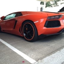 Close Up Of The Rear Of A Lamborghini With Black Alloy Wheels And Orange AlloyGator Alloy Wheel Protectors
