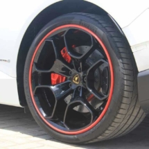 Close Up View Of A White Lamborghini With Black Alloy Wheels And Red AlloyGator Alloy Wheel Protectors